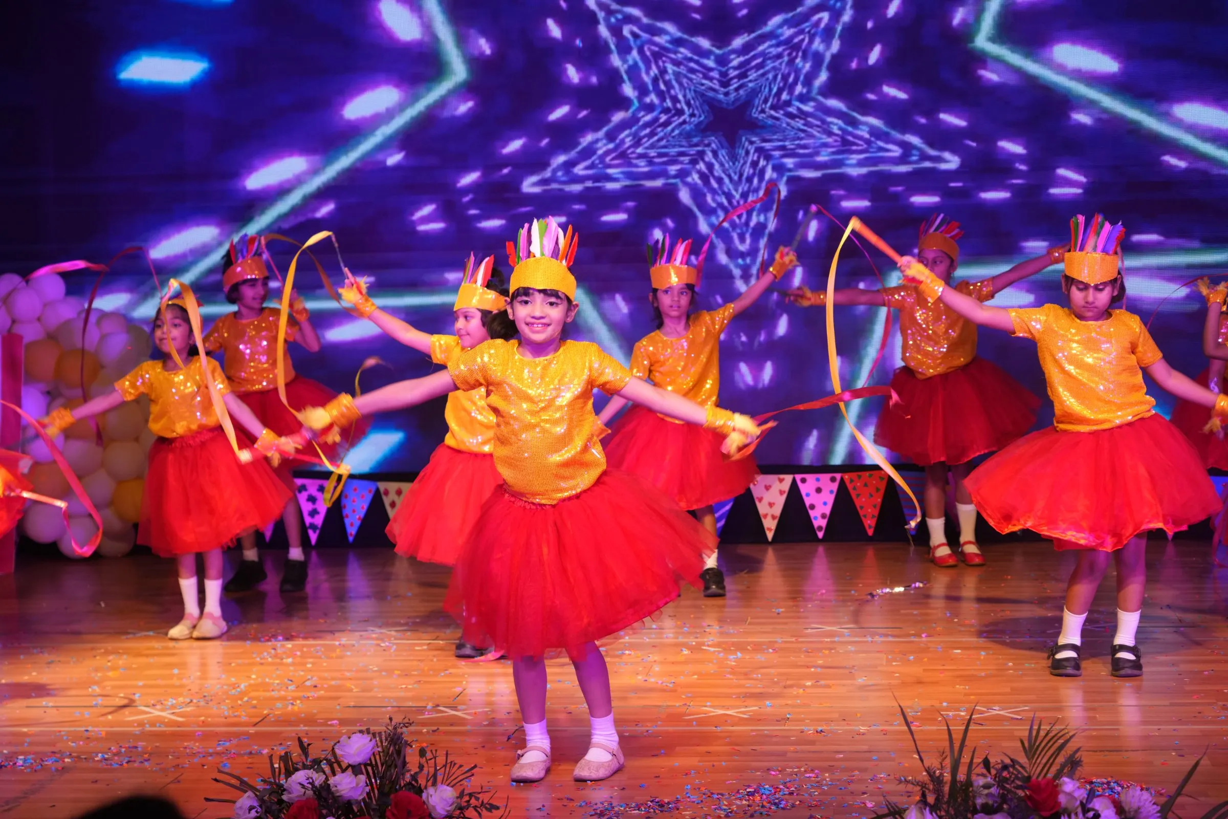 Child Dancing with sticks on stage
