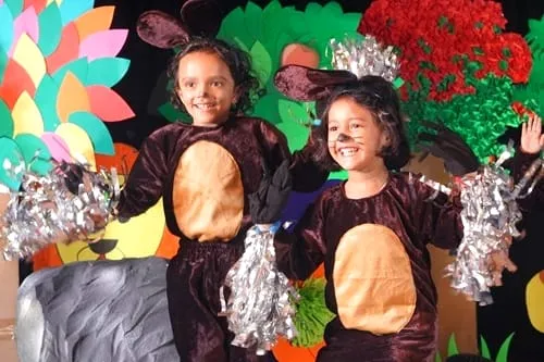 Children in bear costumes performing on stage