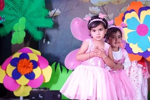 Children dressed as fairies and flowers at the annual day